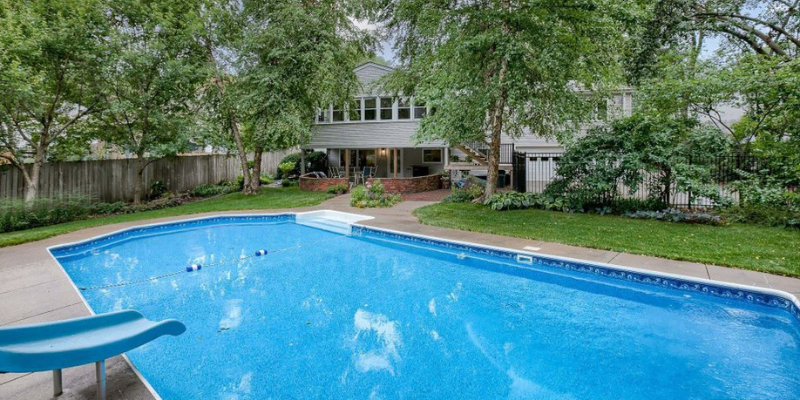 Open Florida pool with moderate tree cover and seasonal debris